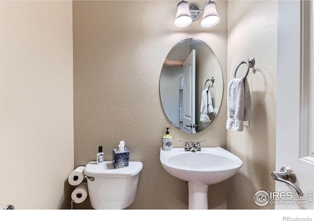 9629 Bountiful St, Firestone, CO 80504 - half bathroom featuring toilet and a textured wall