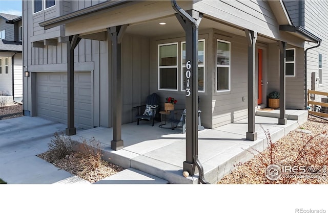 6013 Goodnight Ave, Timnath, CO 80547 - doorway to property with covered porch, board and batten siding, and a garage