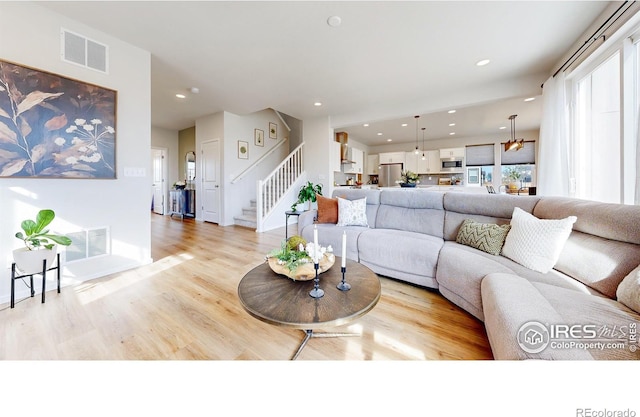 6013 Goodnight Ave, Timnath, CO 80547 - living area featuring stairway, light wood-style flooring, and recessed lighting