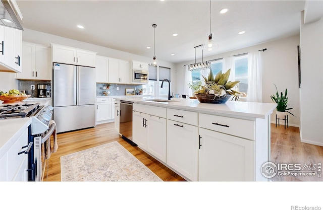 6013 Goodnight Ave, Timnath, CO 80547 - kitchen featuring stainless steel appliances, tasteful backsplash, light countertops, white cabinetry, and recessed lighting