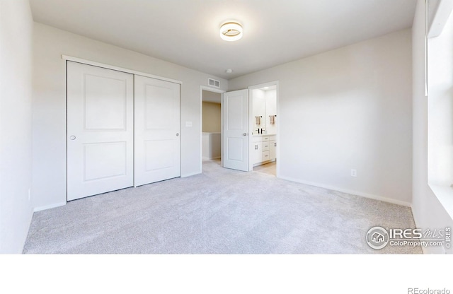 6013 Goodnight Ave, Timnath, CO 80547 - unfurnished bedroom with light colored carpet, a closet, and ensuite bathroom