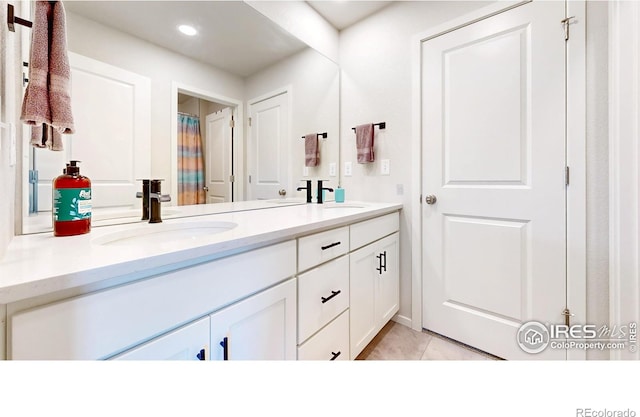 6013 Goodnight Ave, Timnath, CO 80547 - bathroom featuring double vanity, tile patterned floors, and recessed lighting