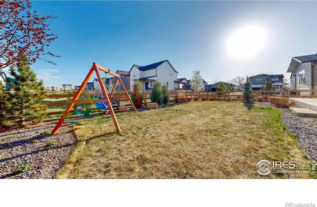 6013 Goodnight Ave, Timnath, CO 80547 - fenced backyard with a playground and a residential view