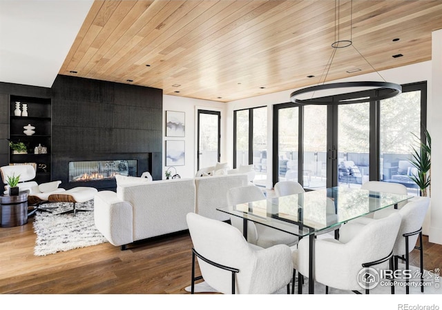358 Arapahoe Ave Unit B, Boulder, CO 80302 - dining room with wood ceiling, dark wood finished floors, a fireplace, built in shelves, and french doors