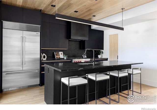 358 Arapahoe Ave Unit B, Boulder, CO 80302 - kitchen featuring stainless steel built in refrigerator, dark cabinets, a breakfast bar, wooden ceiling, and tasteful backsplash