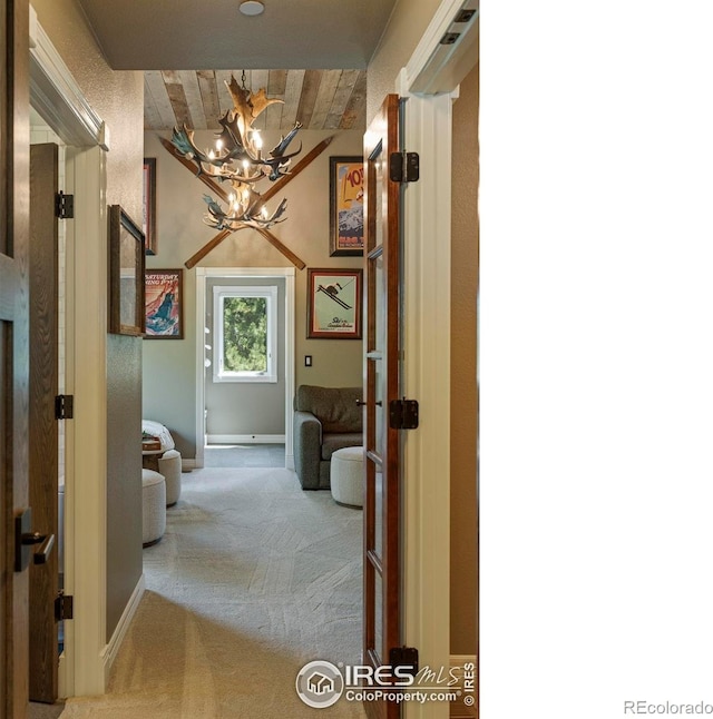 5575 Saint Vrain Rd, Longmont, CO 80503 - hallway with a chandelier, carpet, and wooden ceiling
