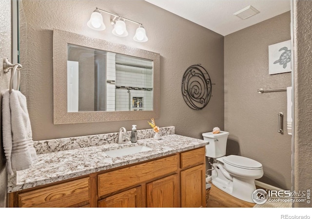 64 Whitehaven Cir, Highlands Ranch, CO 80129 - full bathroom with vanity, a textured wall, and wood finished floors