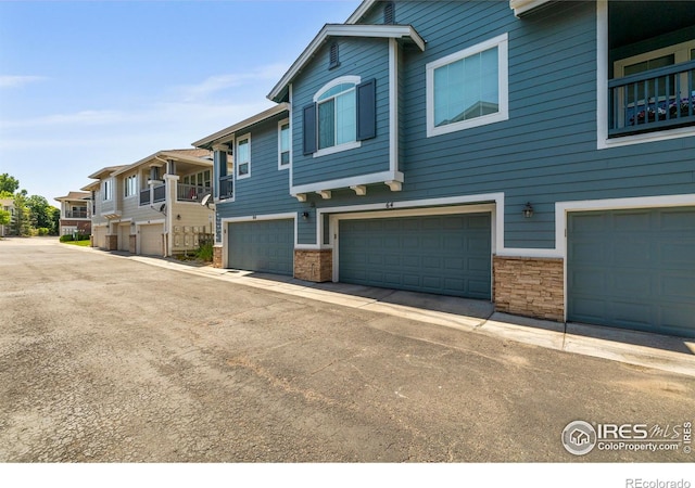 64 Whitehaven Cir, Highlands Ranch, CO 80129 - view of front of house with an attached garage, stone siding, and a residential view