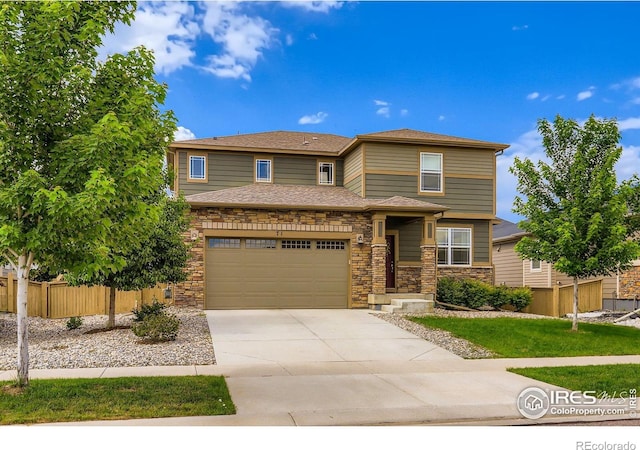 71 Sugar Beet Cir, Longmont, CO 80501 - view of front of home featuring stone siding, concrete driveway, and a garage