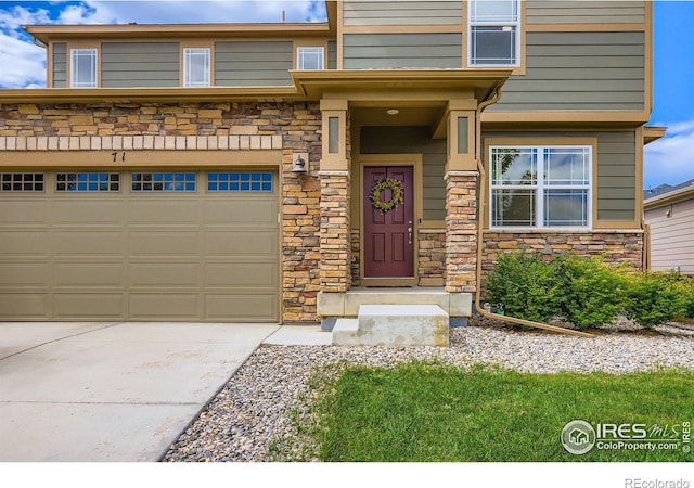 71 Sugar Beet Cir, Longmont, CO 80501 - view of front of home with stone siding, driveway, and a garage