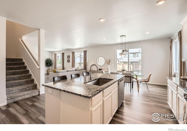 71 Sugar Beet Cir, Longmont, CO 80501 - kitchen featuring dishwasher, dark wood-type flooring, a kitchen island with sink, plenty of natural light, and recessed lighting