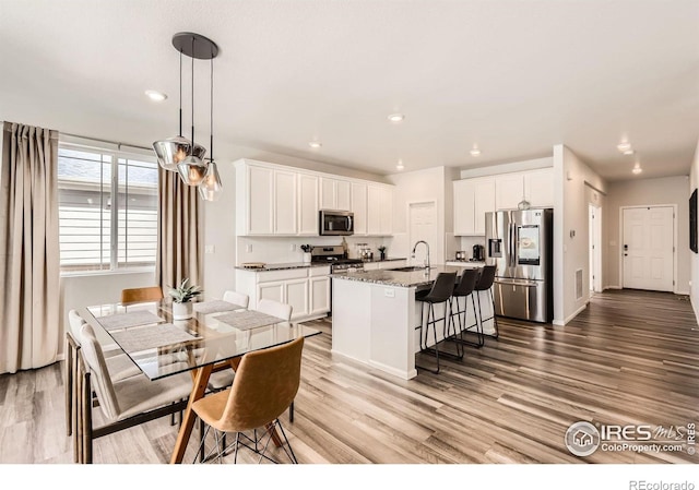 71 Sugar Beet Cir, Longmont, CO 80501 - dining space featuring light wood-style floors and recessed lighting