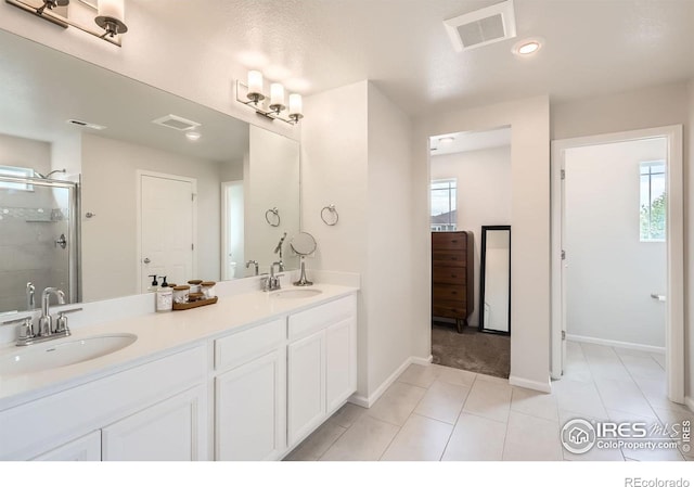 71 Sugar Beet Cir, Longmont, CO 80501 - full bath with healthy amount of natural light, double vanity, a stall shower, tile patterned floors, and recessed lighting