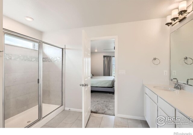 71 Sugar Beet Cir, Longmont, CO 80501 - ensuite bathroom featuring vanity, a shower stall, and tile patterned flooring