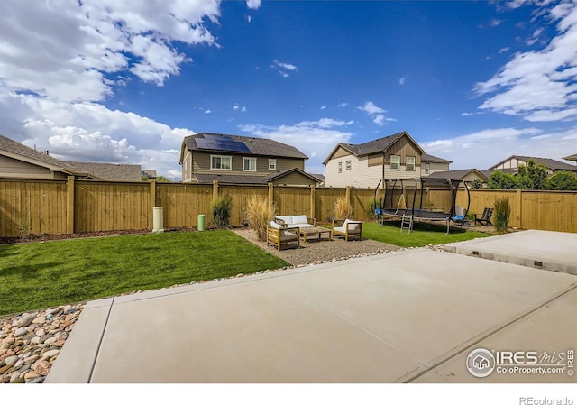 71 Sugar Beet Cir, Longmont, CO 80501 - fenced backyard with a trampoline, a patio area, an outdoor hangout area, and a residential view