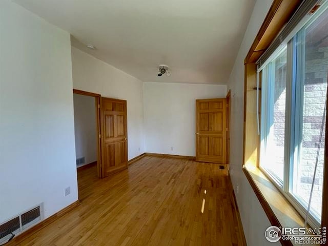 8 Valley View Dr, Nederland, CO 80466 - spare room featuring light wood-style floors and lofted ceiling