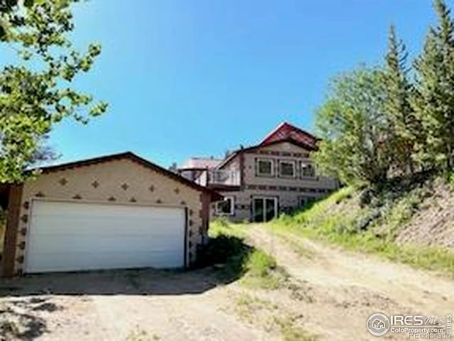 8 Valley View Dr, Nederland, CO 80466 - view of front of property featuring driveway and an attached garage