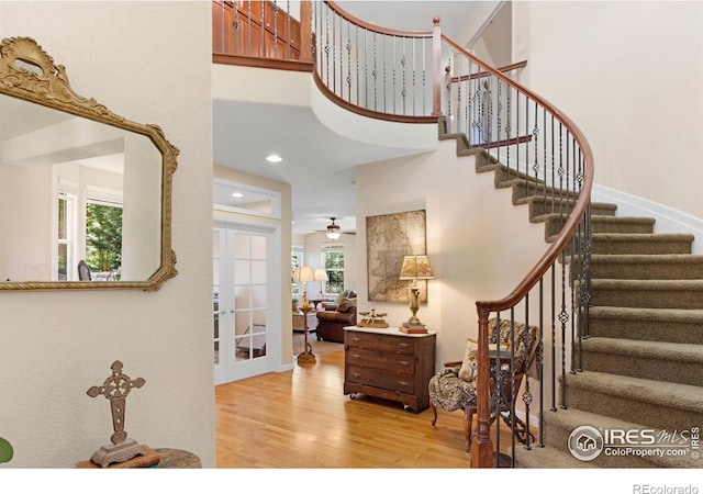 121 Osprey Ln, Lyons, CO 80540 - foyer featuring french doors, wood finished floors, plenty of natural light, stairway, and a high ceiling