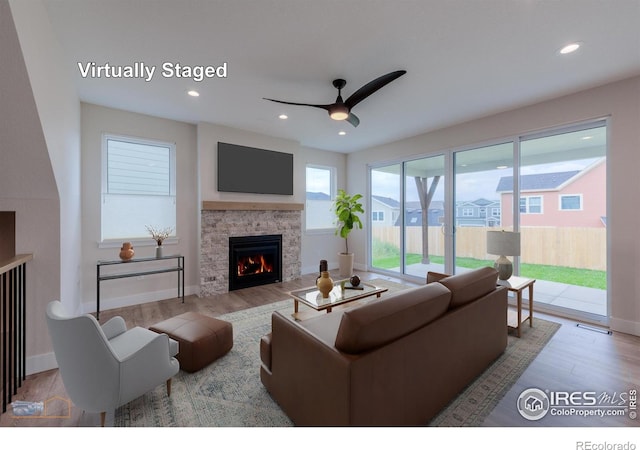 2397 Bristol St, Superior, CO 80027 - living room featuring ceiling fan, wood finished floors, a fireplace, and recessed lighting