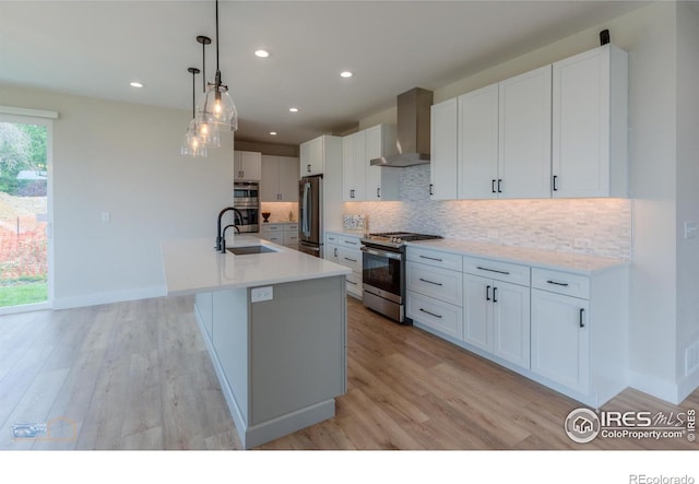2397 Bristol St, Superior, CO 80027 - kitchen featuring appliances with stainless steel finishes, wall chimney range hood, backsplash, light countertops, and recessed lighting