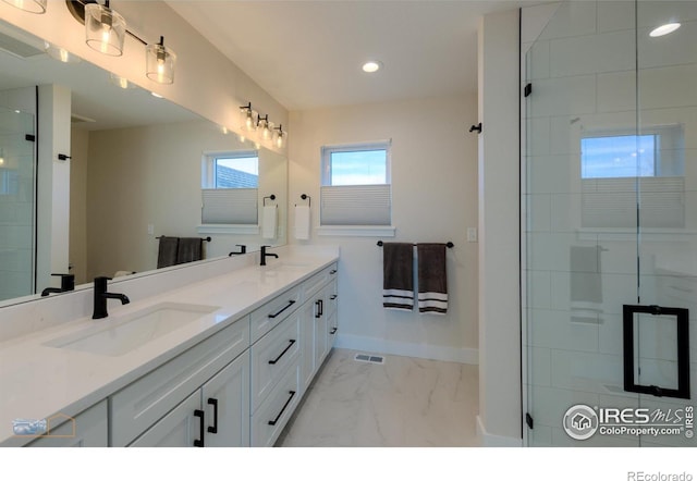 2397 Bristol St, Superior, CO 80027 - bathroom featuring marble look tiles, double vanity, recessed lighting, and a tile shower