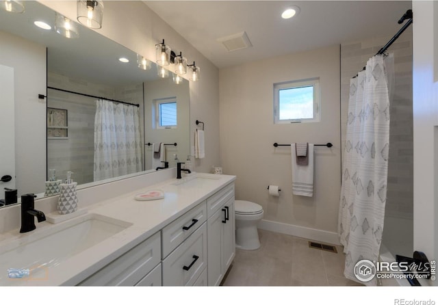 2397 Bristol St, Superior, CO 80027 - full bathroom featuring healthy amount of natural light, double vanity, tile patterned flooring, and recessed lighting