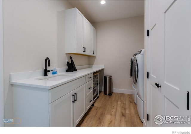 2397 Bristol St, Superior, CO 80027 - washroom with independent washer and dryer, cabinet space, light wood finished floors, wine cooler, and recessed lighting