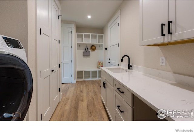2397 Bristol St, Superior, CO 80027 - laundry area with washer / clothes dryer, cabinet space, light wood-type flooring, and recessed lighting