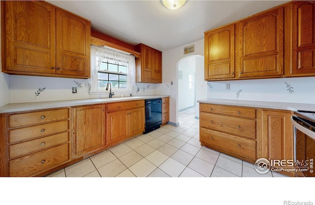595 E Kiser Ave, Keenesburg, CO 80643 - kitchen with dishwasher, arched walkways, light countertops, range, and light tile patterned flooring