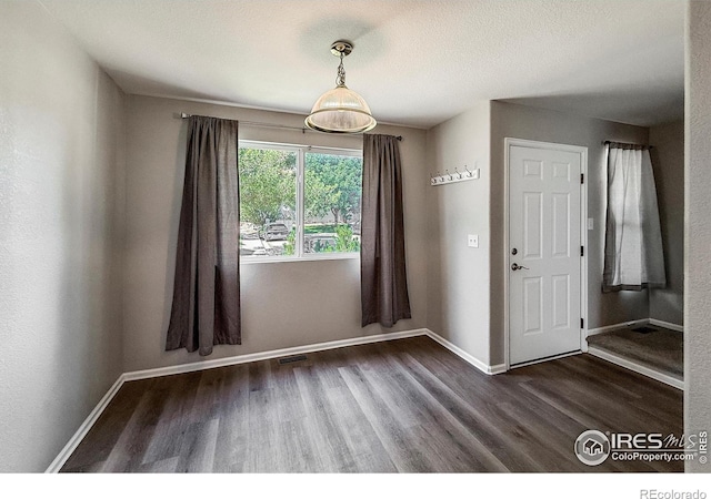 51 21st Ave Unit 43, Longmont, CO 80501 - unfurnished dining area with dark wood-style flooring