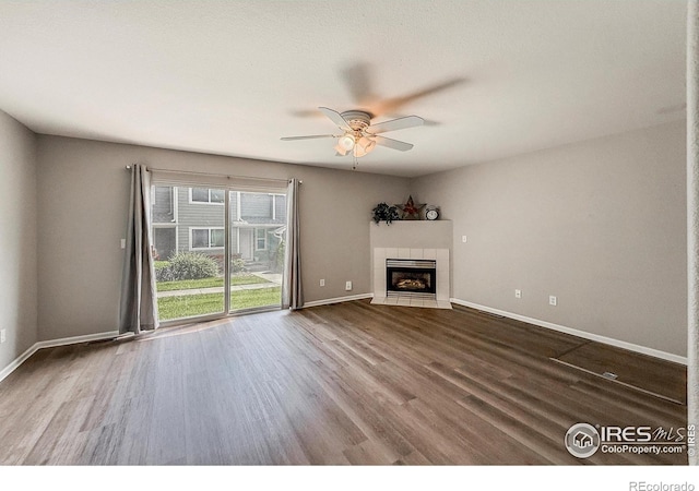 51 21st Ave Unit 43, Longmont, CO 80501 - unfurnished living room with wood finished floors, a ceiling fan, and a tile fireplace