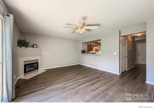 51 21st Ave Unit 43, Longmont, CO 80501 - unfurnished living room featuring wood finished floors, a ceiling fan, and a fireplace