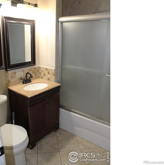 308 Prospect St, Fort Morgan, CO 80701 - full bathroom with vanity, backsplash, bath / shower combo with glass door, and tile patterned floors