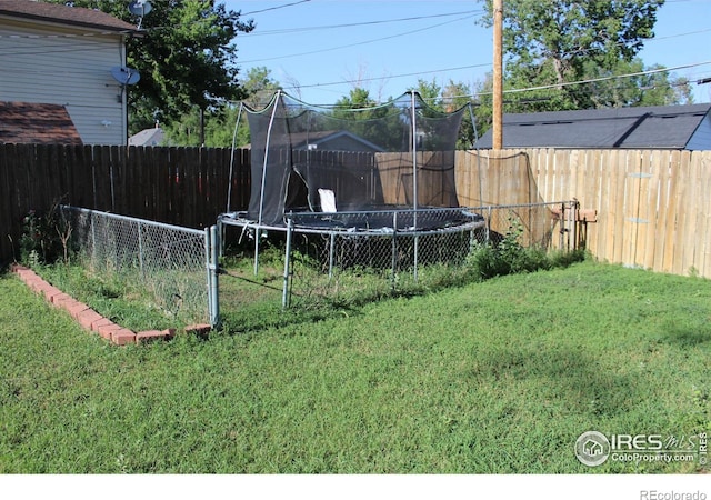 308 Prospect St, Fort Morgan, CO 80701 - fenced backyard with a trampoline