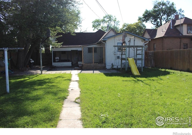 308 Prospect St, Fort Morgan, CO 80701 - rear view of house featuring a patio area and a playground