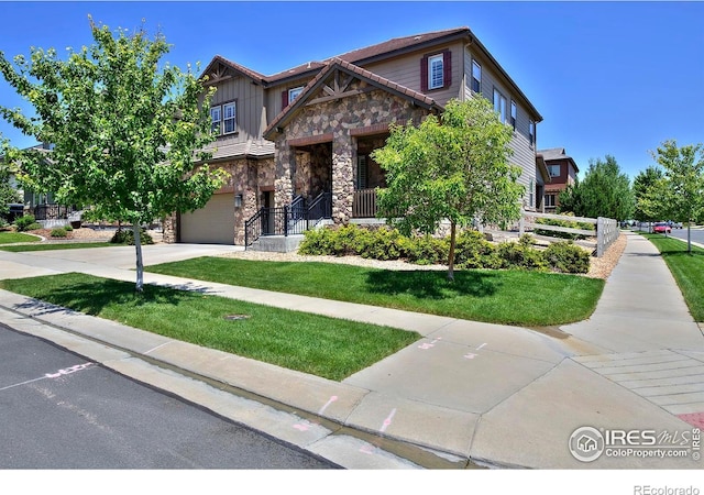 15958 Humboldt Peak Dr, Broomfield, CO 80023 - craftsman inspired home with stone siding, a garage, concrete driveway, a front yard, and board and batten siding