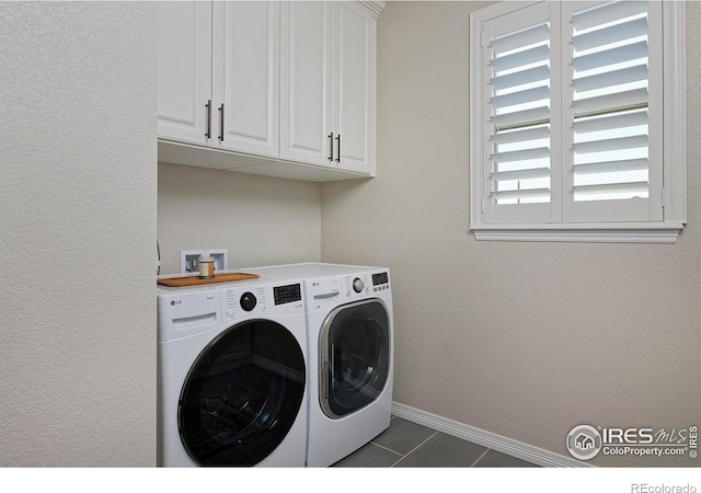 15958 Humboldt Peak Dr, Broomfield, CO 80023 - washroom featuring cabinet space, washing machine and dryer, and dark tile patterned floors