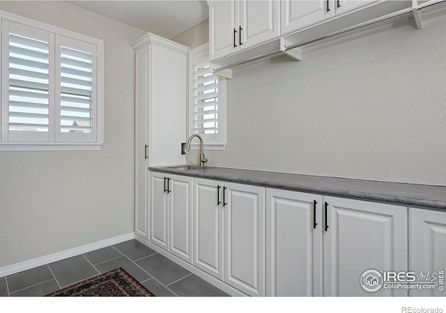 15958 Humboldt Peak Dr, Broomfield, CO 80023 - washroom featuring a sink and dark tile patterned flooring