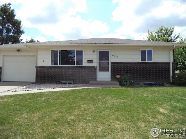 401 31st Ave, Greeley, CO 80634 - view of front facade with brick siding, an attached garage, a front lawn, and concrete driveway