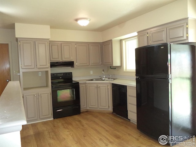 401 31st Ave, Greeley, CO 80634 - kitchen featuring black appliances, under cabinet range hood, light countertops, and light wood-type flooring