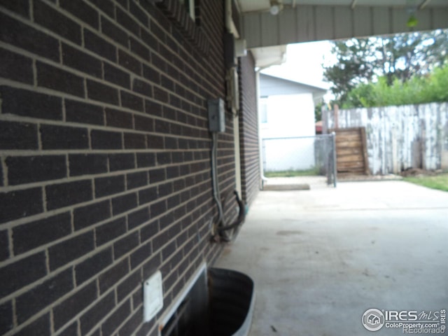 401 31st Ave, Greeley, CO 80634 - view of side of home with board and batten siding, driveway, and a patio
