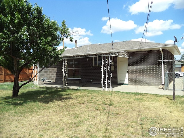 401 31st Ave, Greeley, CO 80634 - back of house with a patio area and brick siding