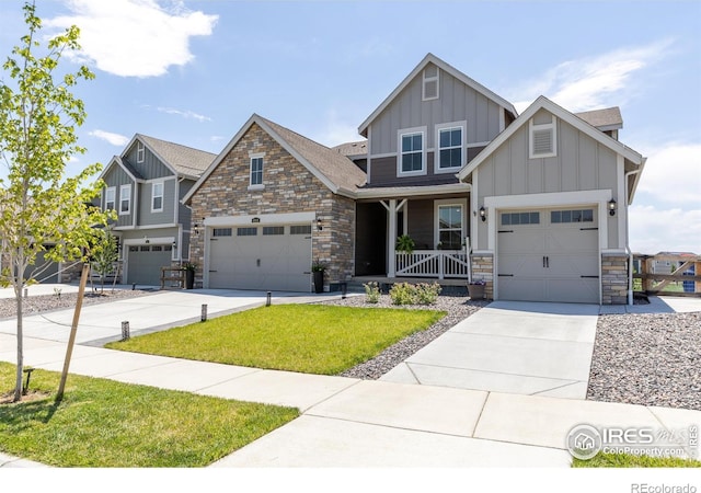 4918 Preserve Pl, Firestone, CO 80504 - craftsman house with board and batten siding, stone siding, concrete driveway, covered porch, and a front lawn
