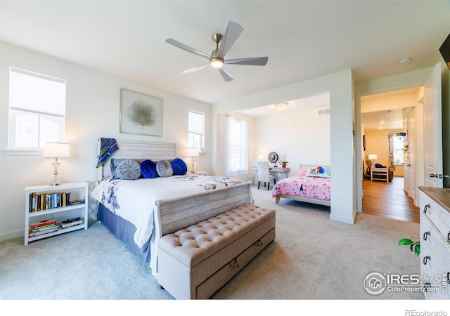 4918 Preserve Pl, Firestone, CO 80504 - carpeted bedroom with multiple windows and a ceiling fan