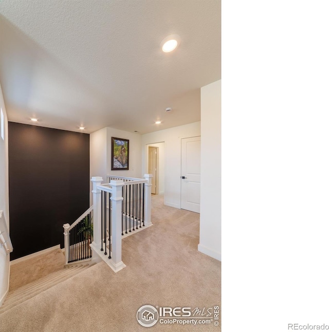 4918 Preserve Pl, Firestone, CO 80504 - hallway featuring an upstairs landing, light carpet, and recessed lighting