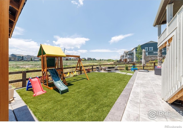4918 Preserve Pl, Firestone, CO 80504 - fenced backyard featuring a playground, a fire pit, and a patio