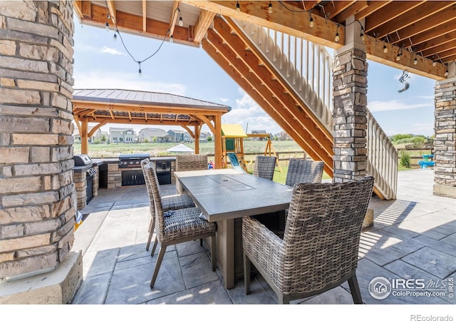 4918 Preserve Pl, Firestone, CO 80504 - view of patio / terrace with an outdoor kitchen, a gazebo, outdoor dining area, and stairs