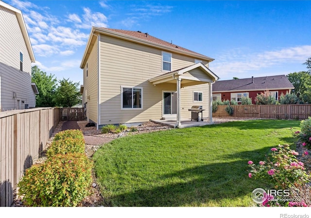 1365 15th Ave, Longmont, CO 80501 - back of property featuring a patio area and a fenced backyard