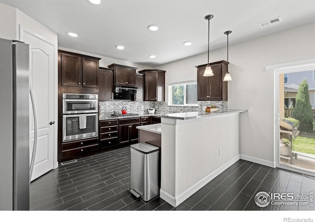 1365 15th Ave, Longmont, CO 80501 - kitchen with stainless steel appliances, decorative backsplash, a peninsula, dark brown cabinets, and wood finish floors