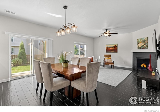 1365 15th Ave, Longmont, CO 80501 - dining room featuring wood tiled floors, ceiling fan, and a tiled fireplace